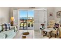 Bright living room with comfortable seating, stylish decor, and a sliding door that leads to the balcony at 4900 Brittany S Dr # 811, St Petersburg, FL 33715