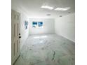 Bright living room featuring new marble tile flooring, fresh paint, and natural light at 547 16Th S Ave, St Petersburg, FL 33701
