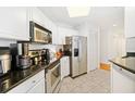 Well-equipped kitchen with stainless steel appliances, black countertops, white cabinets, and ample storage space at 700 S Harbour Island Blvd # 342, Tampa, FL 33602