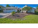 Landscaped front yard with mature shrubs and a brick walkway leading to the entrance at 833 Lakeside Ter, Palm Harbor, FL 34683