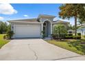 Charming single-story home featuring a well-manicured lawn and a two-car garage in a tranquil neighborhood at 11220 Godwit Ct, New Port Richey, FL 34654