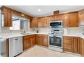 Updated kitchen featuring stainless steel appliances, wooden cabinets, and tiled flooring at 1403 Garden Ave, Tarpon Springs, FL 34689