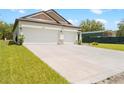 Exterior of house with a 3-car garage showcasing a spacious driveway and manicured front yard at 15062 Hummingbird Rd, Weeki Wachee, FL 34614
