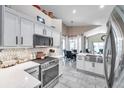 Bright, modern kitchen with white cabinets, stainless steel appliances, and an open layout at 1747 Wood Brook St, Tarpon Springs, FL 34689