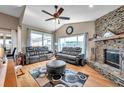 Comfortable living room with a stone fireplace, hardwood floors, and ample natural light at 1747 Wood Brook St, Tarpon Springs, FL 34689