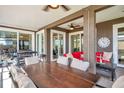 Covered patio with dining and lounge area, perfect for outdoor entertaining with ceiling fans and sliding doors at 1747 Wood Brook St, Tarpon Springs, FL 34689