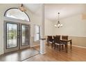 Bright dining room featuring laminate floors, modern lighting and foyer with double doors at 1831 Stable Trl, Palm Harbor, FL 34685