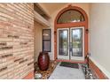 Close up of front entrance with double doors, planters and arched window at 1831 Stable Trl, Palm Harbor, FL 34685