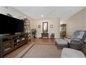 Inviting living room with hardwood floors, a large TV, and comfortable seating with a view of a hallway at 2021 Shangrila Dr # 14, Clearwater, FL 33763