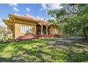Lovely brick home with prominent front porch and steps leading up to the house at 2710 N Dundee St, Tampa, FL 33629
