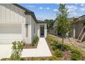 Charming home entrance with a tidy walkway, manicured landscaping, and a secure front door at 3737 Nandina Cir, Sun City Center, FL 33573