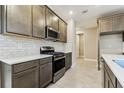 Well-equipped kitchen features stainless steel appliances, subway tile backsplash, and ample cabinet space at 3737 Nandina Cir, Sun City Center, FL 33573