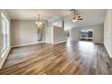 Open-concept living room with hardwood floors and an abundance of natural light at 37437 Laurel Hammock Dr, Zephyrhills, FL 33541