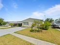 Well-kept single-story home with a covered carport and manicured lawn, offering great curb appeal at 37639 Newport Dr, Zephyrhills, FL 33542