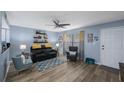 Comfortable living room with modern ceiling fan, wood flooring, stylish decor, and lots of natural light at 404 Hammock Pine Blvd # 404, Clearwater, FL 33761
