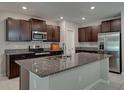 Open kitchen showcasing granite countertops, stainless steel appliances, and ample cabinet space at 413 Royal Empress Dr, Ruskin, FL 33570