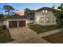 View of the home's exterior, showcasing the detached two car garage and extended driveway at 444 49Th N St, St Petersburg, FL 33710