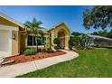 Home's walkway and landscaping leading to the front entrance at 4452 Bardsdale Dr, Palm Harbor, FL 34685