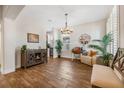 Bright, open living room features modern furnishings, decor, and wood flooring at 4808 Jackson Club Loop, Tampa, FL 33624