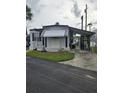 Street view of a single-story home with a carport and well-maintained landscaping at 4851 W Gandy Blvd # B3L12, Tampa, FL 33611