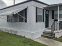 Quaint front porch and door of this single story home features a small garden at 4851 W Gandy Blvd # B3L12, Tampa, FL 33611
