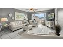 Bright living room with tile flooring, stylish decor, and water views at 5157 Silent Loop # 214, New Port Richey, FL 34652