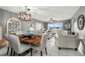 Open-concept living and dining room with modern lighting and waterfront views at 5157 Silent Loop # 214, New Port Richey, FL 34652