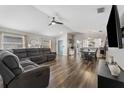 Spacious living room featuring wood floors, a ceiling fan, and ample natural light at 518 Royal Ridge St, Valrico, FL 33594