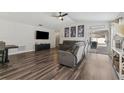 Cozy living room with wood floors, recessed lighting, and sliding glass doors to the patio at 518 Royal Ridge St, Valrico, FL 33594