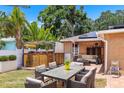 Outdoor backyard featuring brick pavers, hot tub, outdoor seating, and lush greenery at 5324 3Rd N Ave, St Petersburg, FL 33710