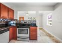 Bright kitchen featuring stainless steel appliances, wooden cabinets, and an eat-in dining area at 5324 3Rd N Ave, St Petersburg, FL 33710