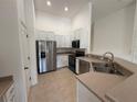 Bright kitchen featuring stainless steel appliances and white cabinetry at 5527 Kinglethill Dr, Lithia, FL 33547