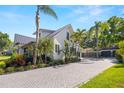 Beautiful home features a long driveway, mature trees, and a detached two-car garage at 5610 N River Shore Dr, Tampa, FL 33603