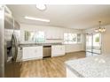 Modern kitchen featuring stainless steel appliances, granite countertops, and tile flooring at 5670 Postma St, North Port, FL 34287