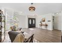 Bright foyer with modern flooring, spiral staircase and double front doors at 640 Kenneth Way, Tarpon Springs, FL 34689
