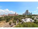 An exterior view of a charming cityscape with buildings, palm trees and a view of the sky at 700 Beach Ne Dr # 705, St Petersburg, FL 33701