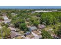 Aerial view of a neighborhood featuring lush trees, residential streets, and houses at 705 Cypress St, Tarpon Springs, FL 34689