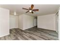 Bright living room featuring modern flooring, neutral walls, and a ceiling fan at 7517 Oxwood St, North Port, FL 34287