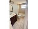 Cozy bathroom featuring neutral tile and a shower-tub combination, providing a comfortable and functional space at 7734 Judith Cres, Port Richey, FL 34668