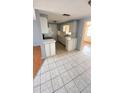 Bright kitchen featuring white cabinets, tile flooring, and ample counter space, perfect for culinary enthusiasts at 7734 Judith Cres, Port Richey, FL 34668