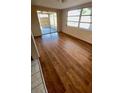 Open living room with wood-look flooring and lots of natural light, creating a warm and inviting space at 7734 Judith Cres, Port Richey, FL 34668
