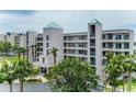 Attractive condo building featuring a well-maintained exterior and lush tropical landscaping at 8000 Sailboat Key S Blvd # 202, St Pete Beach, FL 33707
