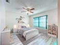 Cozy ' bedroom with plenty of natural light, soft rug, and neutral color palette at 8127 Tarsier Ave, New Port Richey, FL 34653