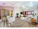 Spacious living room with vaulted ceilings, skylights, and modern decor at 8127 Tarsier Ave, New Port Richey, FL 34653