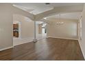 Open-concept living room with hardwood floors and elegant architectural details at 8211 Canyon Creek Way, Tampa, FL 33647