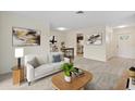 Inviting living room featuring neutral tones, stylish decor, and an open floor plan with an adjacent dining area at 9922 86Th Way, Seminole, FL 33777
