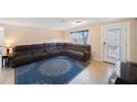 Spacious living room featuring tile flooring, a large sectional sofa, and ample natural light at 1159 19Th Sw Ave, Largo, FL 33778