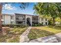Charming two-story condo featuring a beautifully landscaped lawn and screened-in balconies at 1281 Pine Ridge E Cir # H1, Tarpon Springs, FL 34688