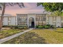 Charming two-story condo featuring a beautifully landscaped lawn and screened-in balconies at 1281 Pine Ridge E Cir # H1, Tarpon Springs, FL 34688