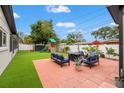 Cozy backyard patio with comfortable seating and a lush artificial lawn at 1529 79Th N Ave, St Petersburg, FL 33702